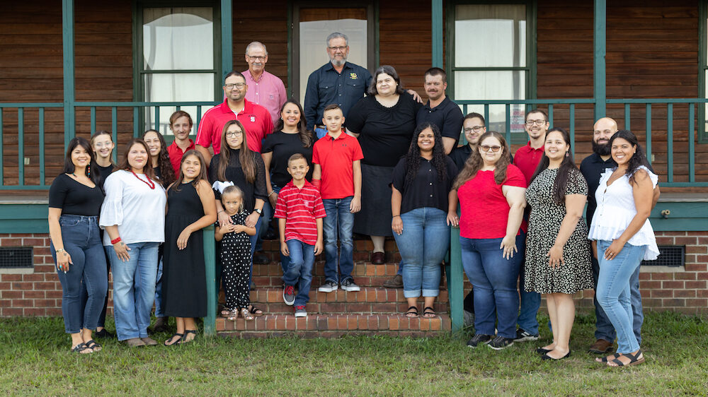 Moore family stands all together for a photo.