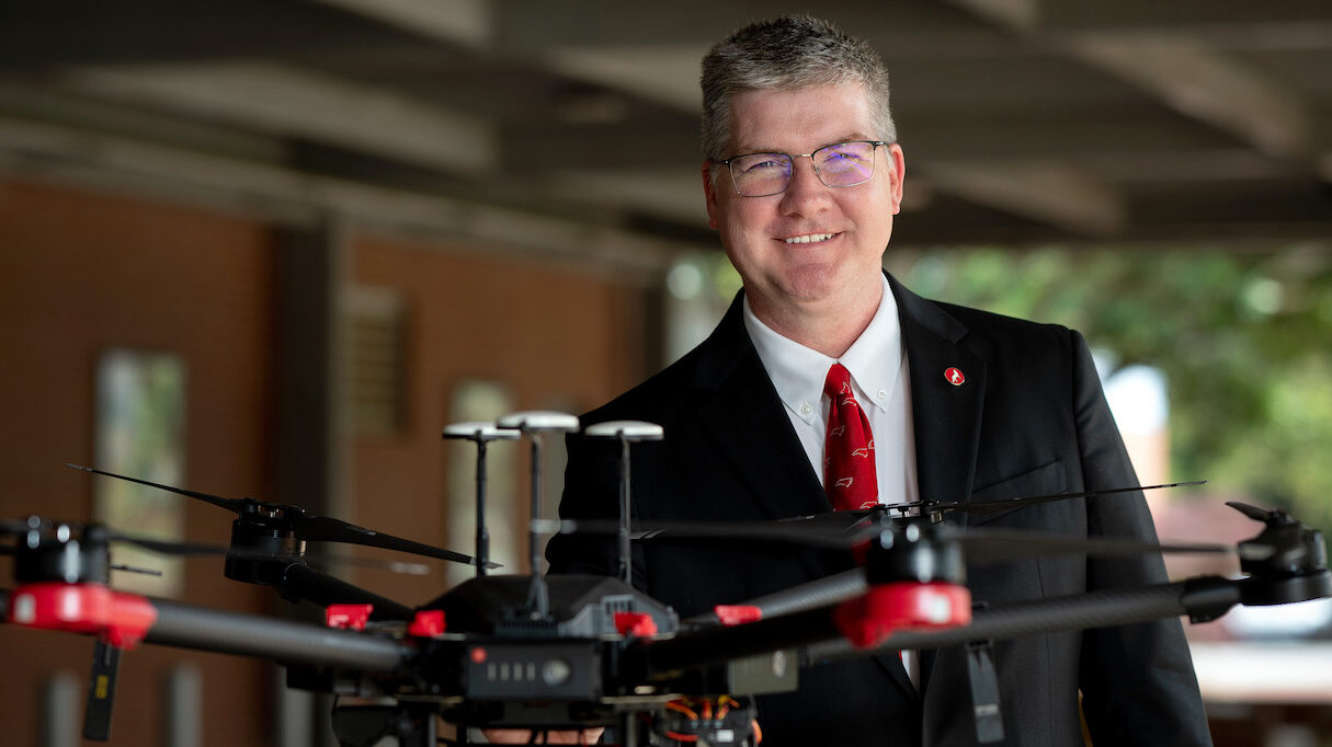 CALS Dean Garey Fox stands with a drone