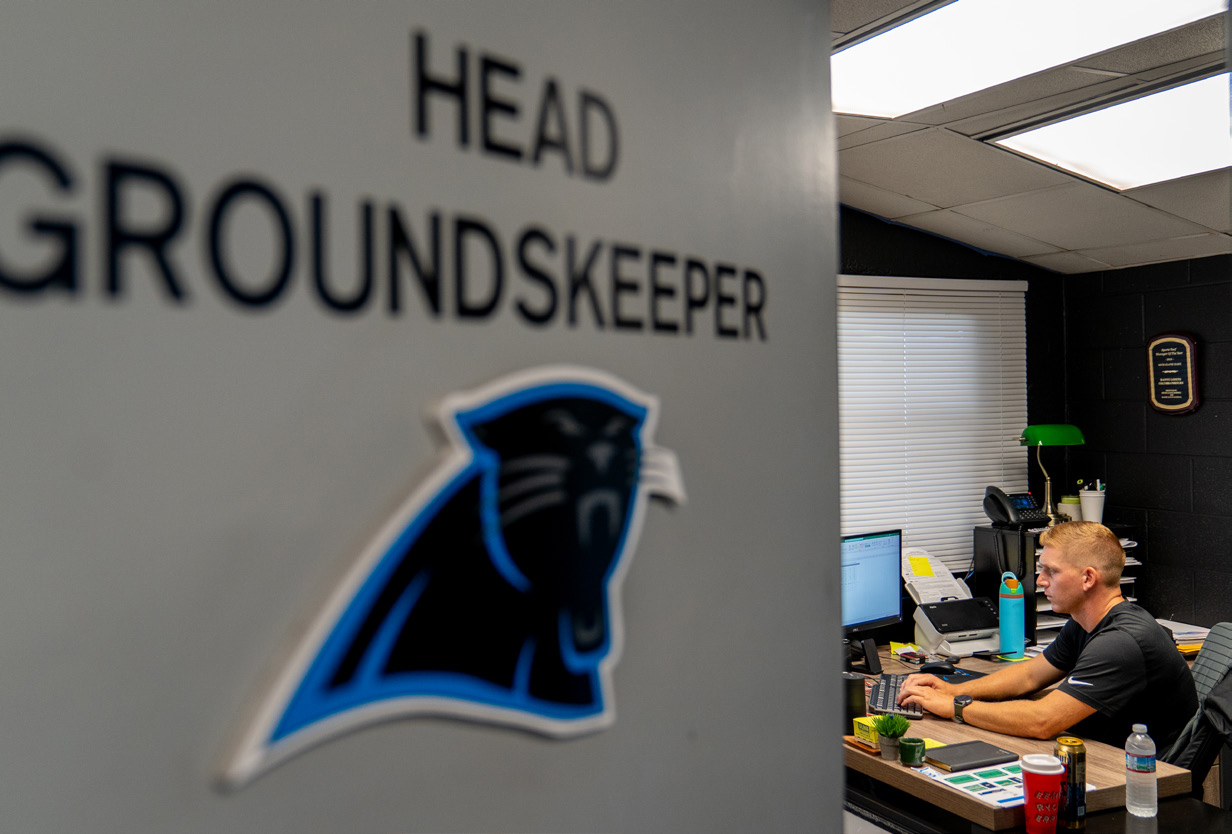 Man in office with Panthers logo on door