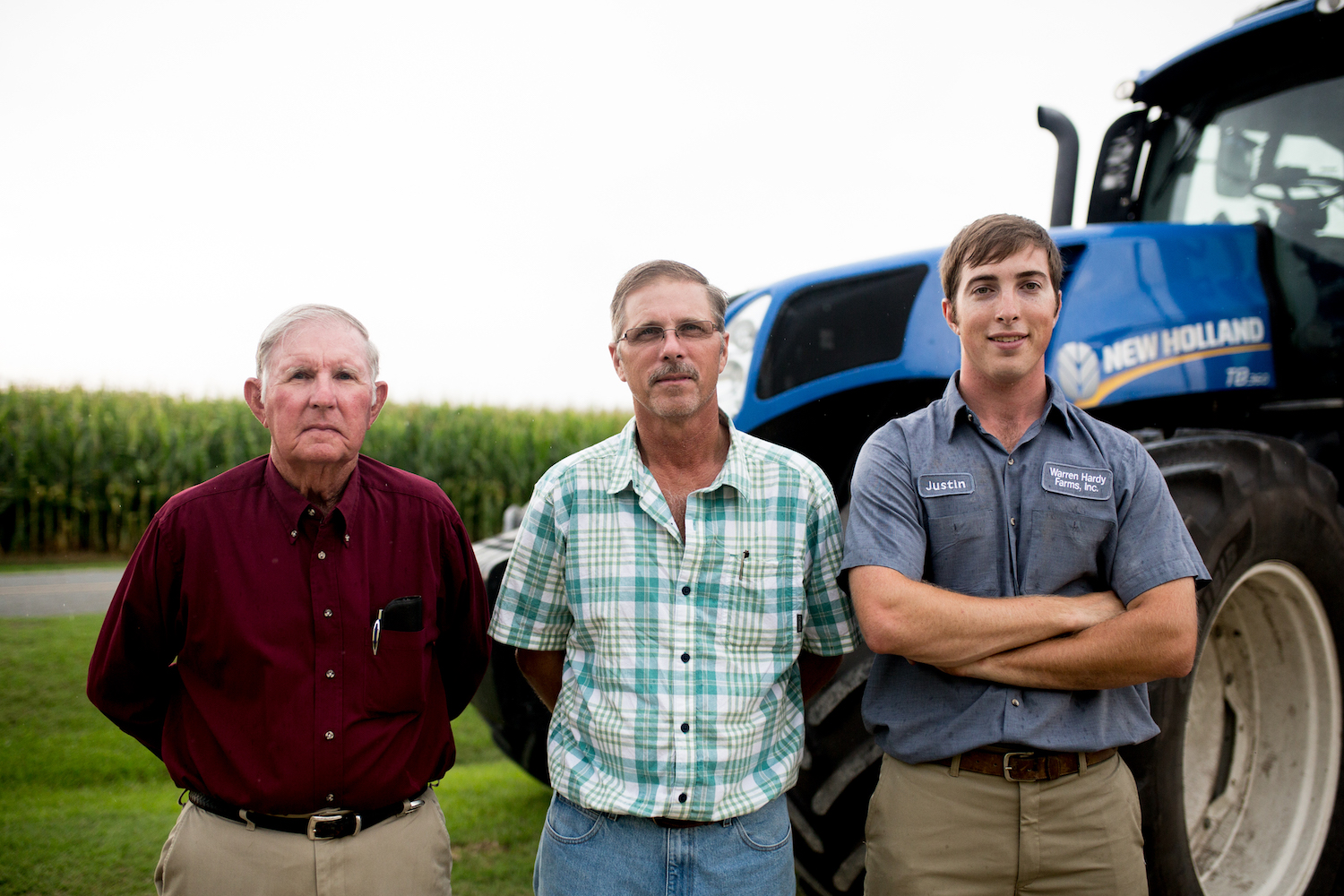 Sylvan, Warren and Justin Hardy stand on their farm.