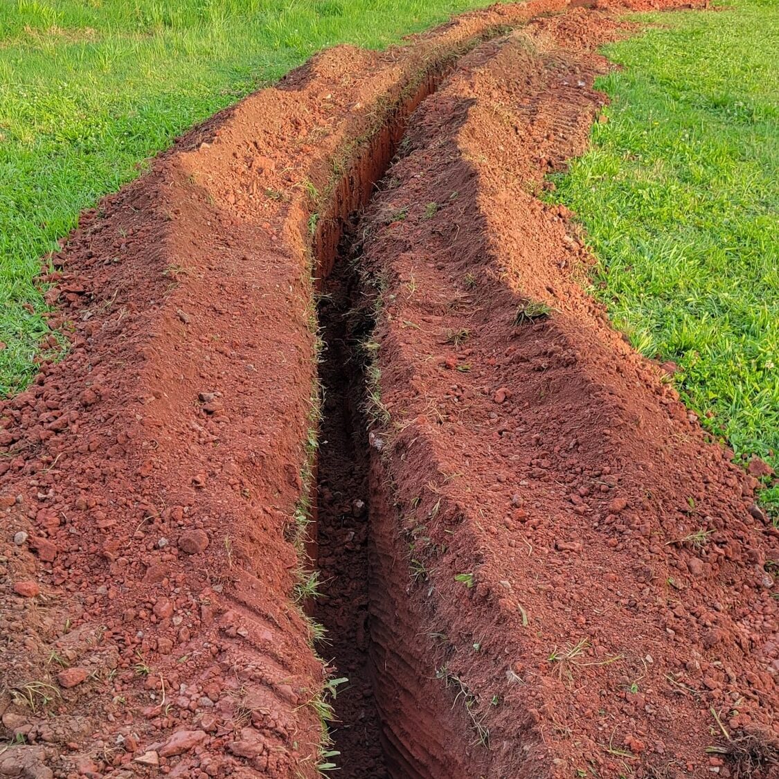 A trench that was dug to lay fiber optic cables underground.