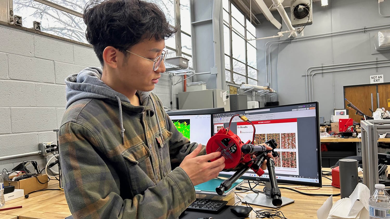 Weilong He examining a sensor device