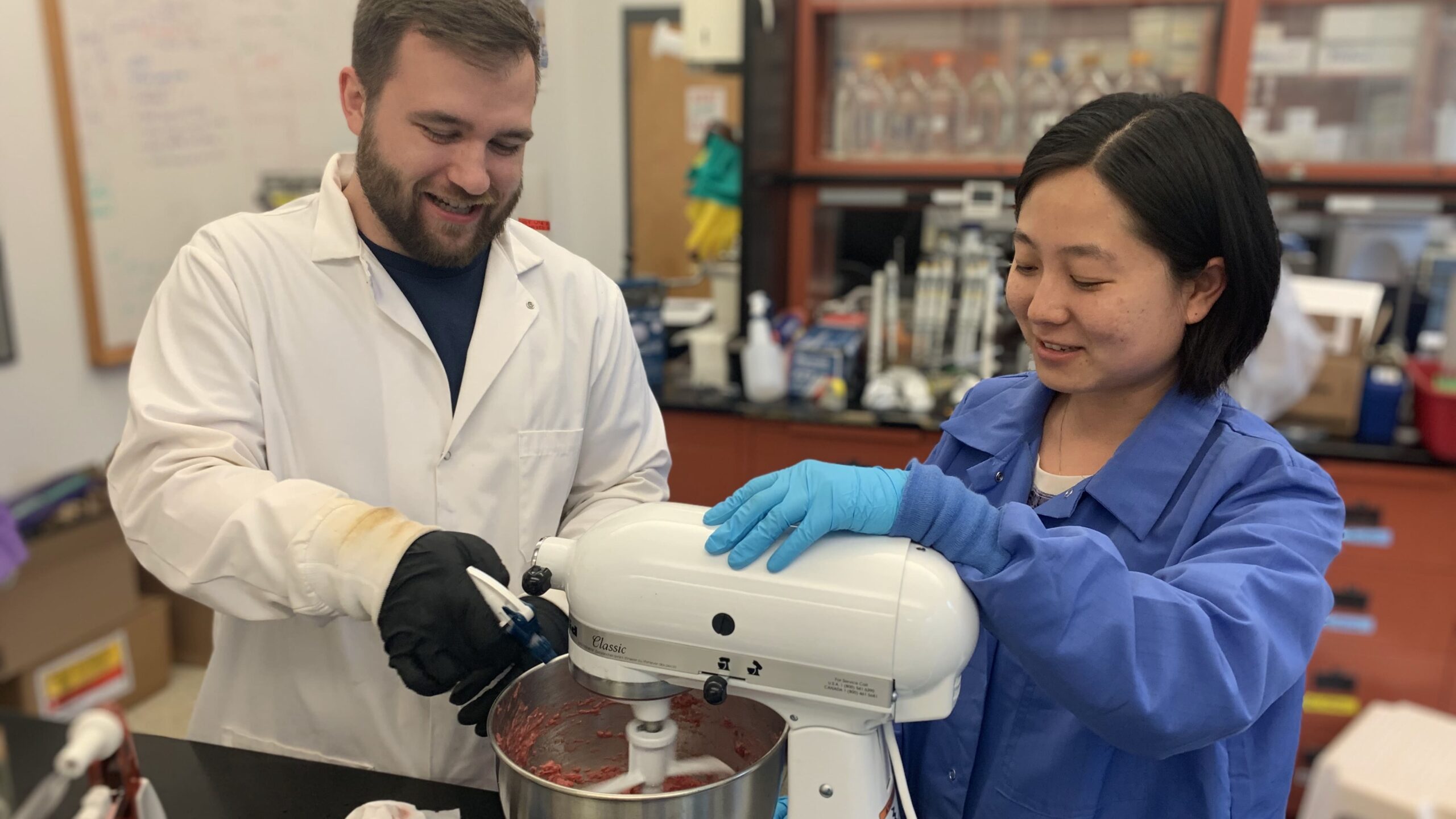 Lin Walker, assistant professor of poultry science, and Ph.D. student Justin Lowery working on a microbiology study for pet food.