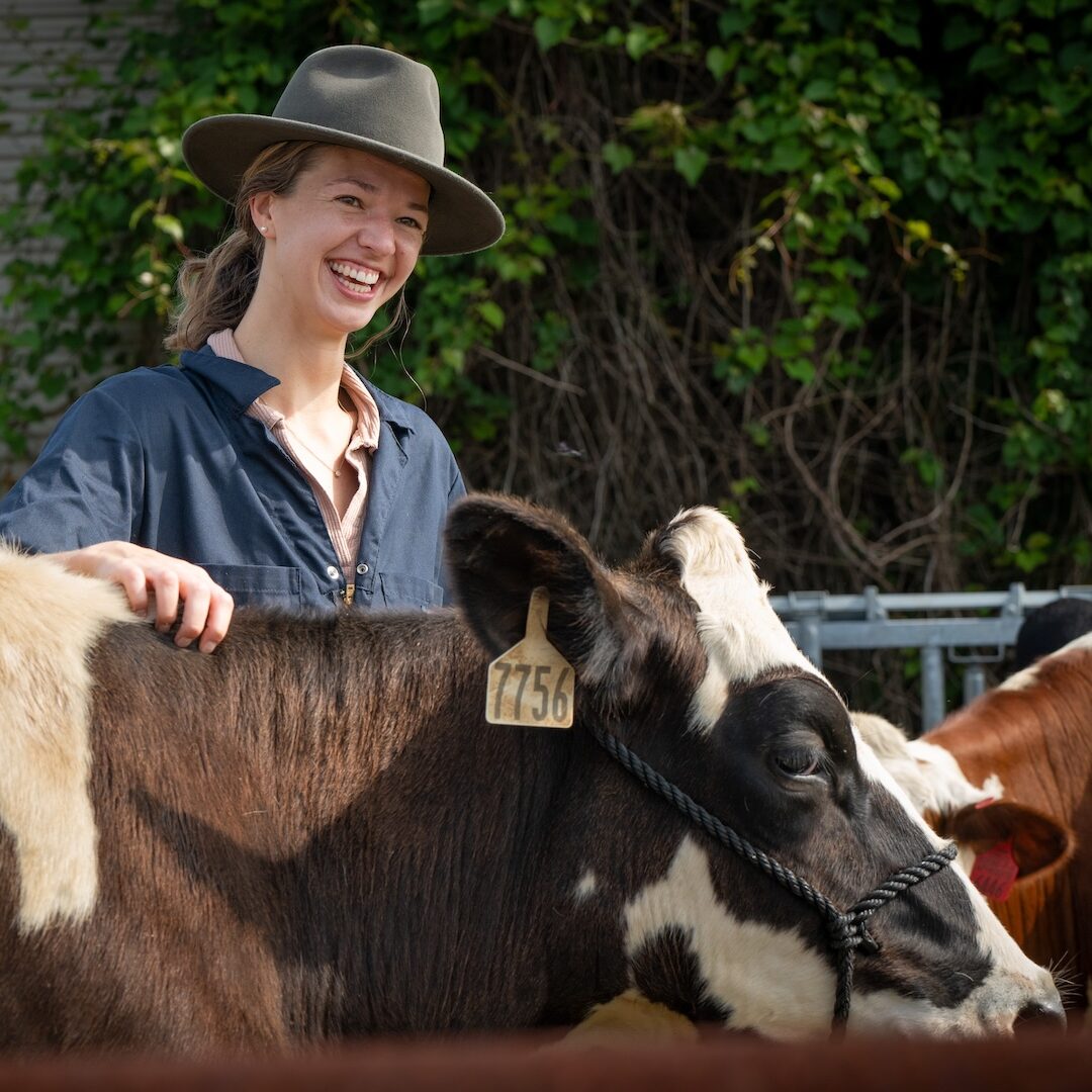 woman smiling with a cow