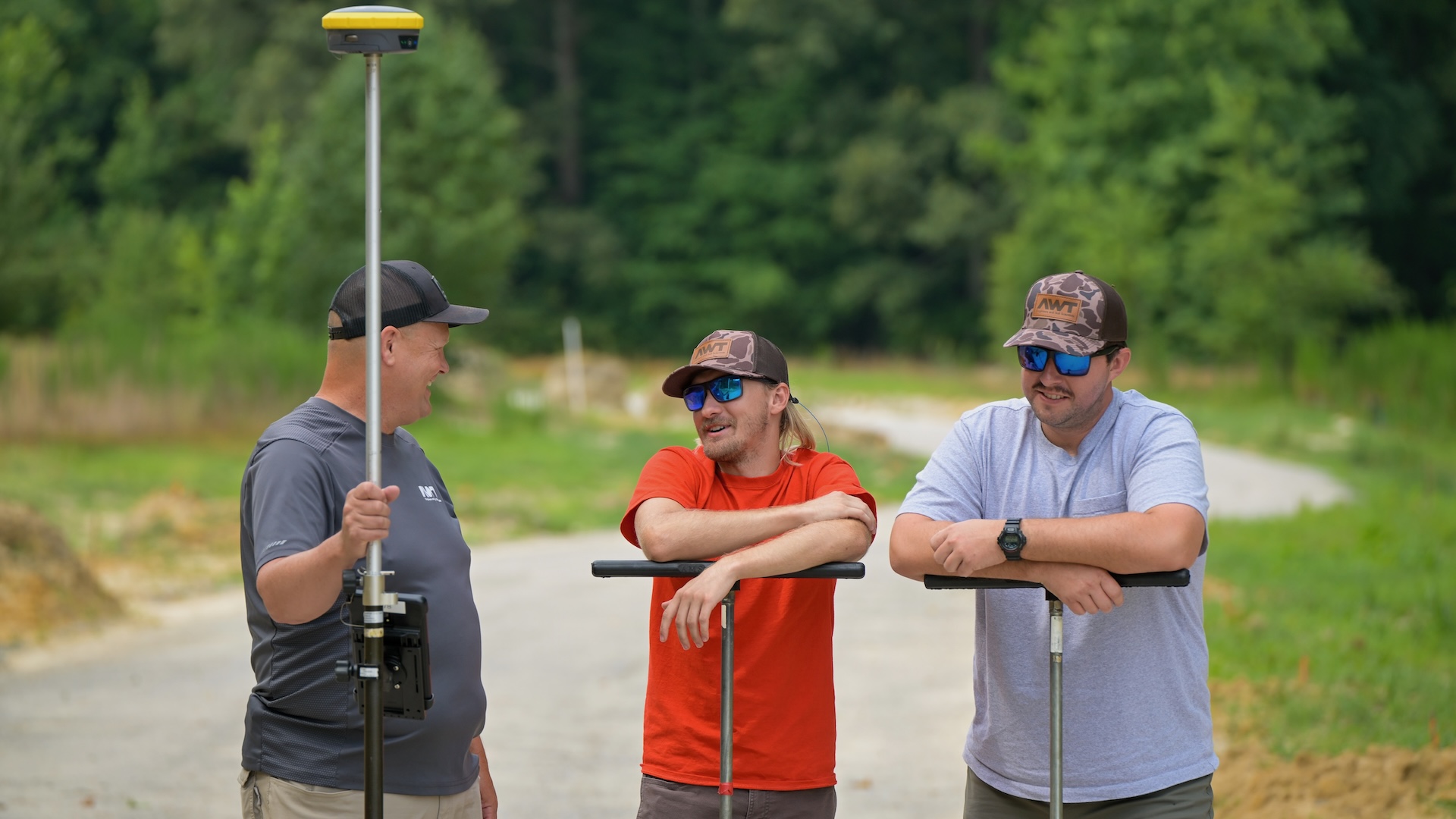 three men standing in a road