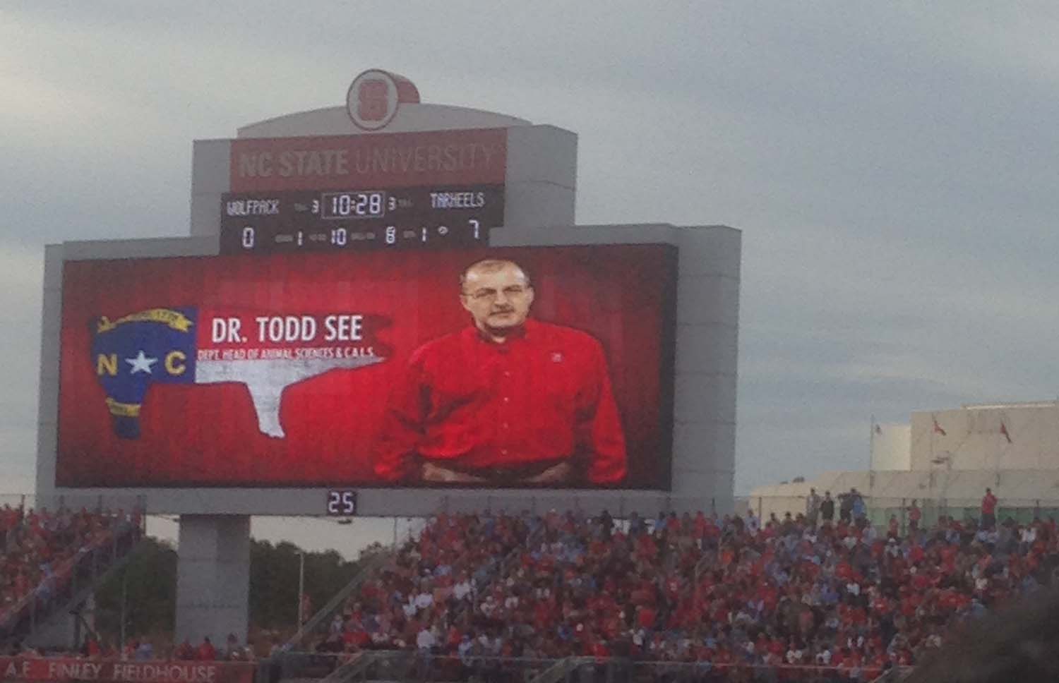 a man wearing a jumbo tron wearing red shirt talking in a taped message