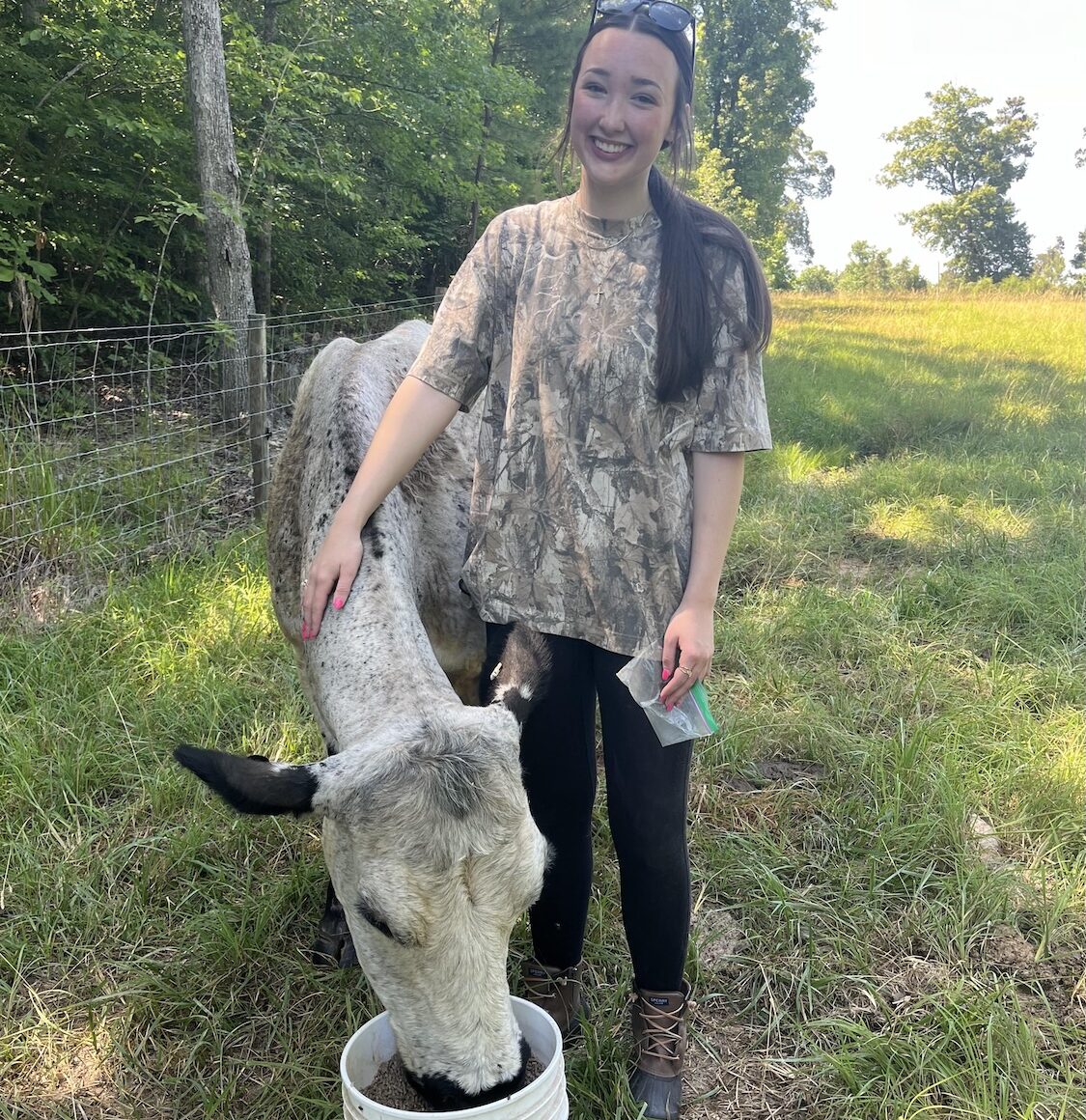 woman standing with a cow